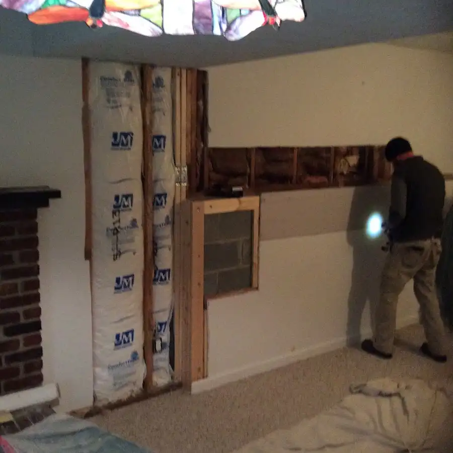 Restoration technician inspecting water damage in Kailua